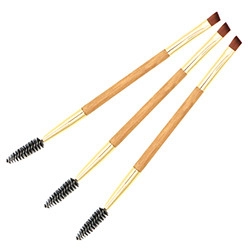 Detail showing three double-ended bamboo eyebrow and eyelash brushes with gold ferrules