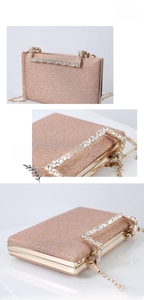 Detail of glitter evening clutch with rhinestone handle and champagne sequin finish