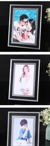 Close-up of modern black and silver glass photo frame with elegant brushed metal textures