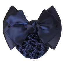 Detail of navy blue satin bow hair clip with mesh net for professional hair styling
