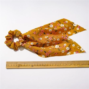 Floral long ribbon scrunchie in yellow chiffon with 32cm length shown on scale