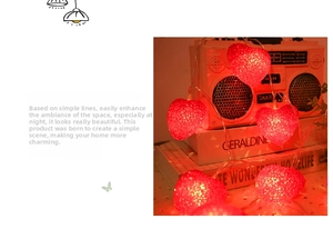 Detail of red heart LED string lights with warm glow over vintage home decor items