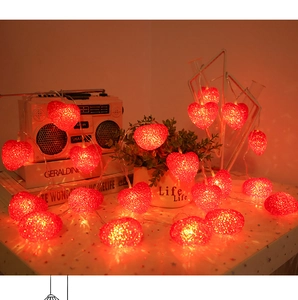 Close-up of heart-shaped LED string lights with red glitter texture for festive decor