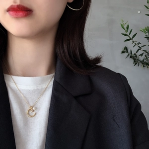 Close-up of a S925 sterling silver crescent moon pendant with a pearl and gold chain