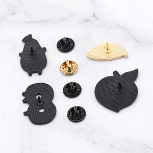 Creative enamel pin set featuring cartoon fruit and ghost shapes on marble background