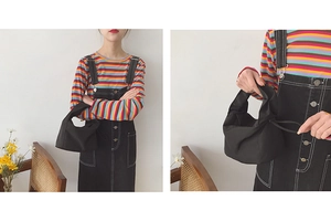 Détail du sac baguette noir minimaliste en toile avec fermeture par cordon coulissant