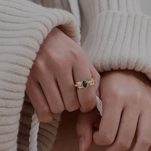 18K gold plated stainless steel ring featuring a green oval gemstone and textured band
