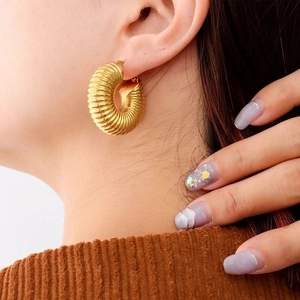 Chunky gold-plated stainless steel croissant hoop earrings with a textured ribbed design