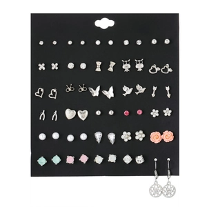 Detailed view of colorful stud earrings set with rhinestones and pearls on display