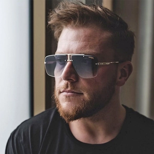 Close-up of frameless gradient sunglasses with metal double-bridge and gold-tone temples