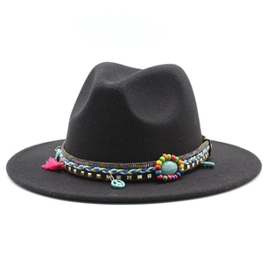 Close-up of black wool fedora featuring bohemian beads and turquoise ethnic detailing