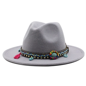 Detail of gray wool fedora featuring ethnic band with turquoise bead and tassels