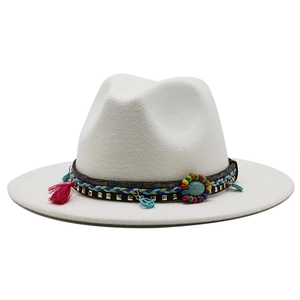 Close-up of white wool fedora featuring bohemian braided band and turquoise charms