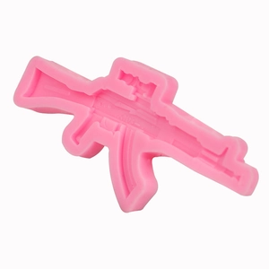 Pink silicone mold shaped like an AK-47 assault rifle for fondant and DIY crafts