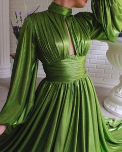Detail of avocado green pleated maxi dress with high neck cutout and waist-cinching silhouette