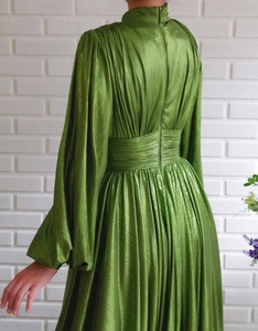 Rear view of avocado green pleated maxi dress with high neck and cinched waist detail