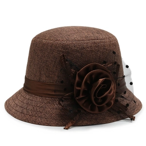 Elegant brown linen bucket hat for women with large flower and black polka dot veil