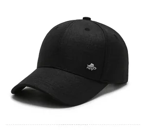 Close-up of black cotton baseball cap showing silver RZG metal logo and fabric texture