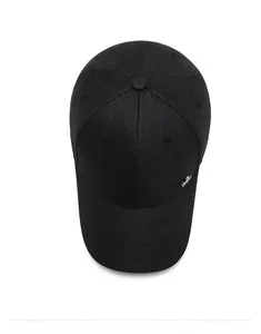 Top down view of black baseball cap showing six-panel crown and metal logo detail