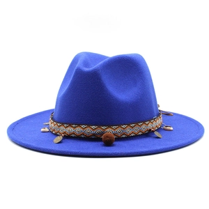 Detail of navy wool fedora showing ethnic woven band with shells and copper charms