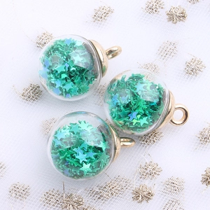 Detail of green star sequin glass globe charms with gold loops for DIY jewelry making