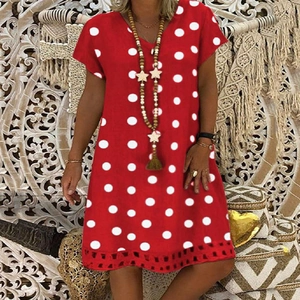 Close-up of V-neck red polka dot dress with intricate lace hem and cutout details