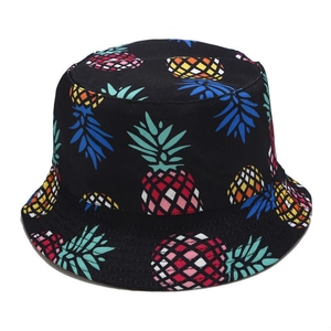 Close-up of colorful pineapple pattern on a black cotton bucket hat with fine stitching