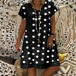 Detail of V-neckline and white polka dot pattern on black short sleeve midi dress