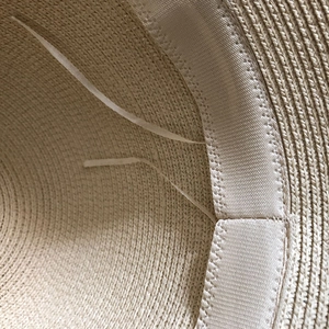Detailed interior of woven straw hat showing the sweatband and adjustable drawstring