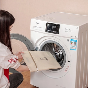 Putting a fine mesh laundry bag with dress icon into a front load washing machine