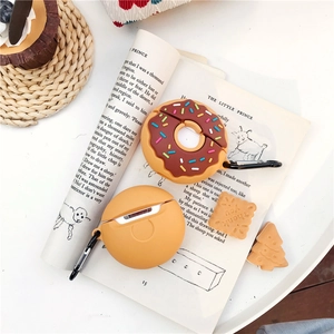Detail of silicone donut and orange AirPods case with black hook and biscuit accessories