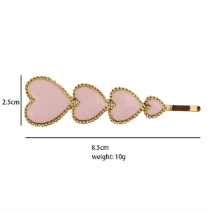 Detail of pink heart hair clip with gold finish showing dimensions 8.5cm and 10g weight