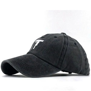 Side view detail of black washed cotton baseball cap with white letter T embroidery