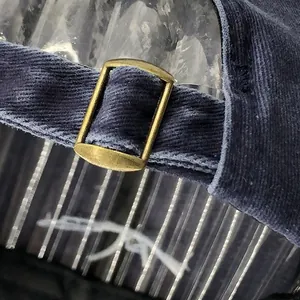 Macro detail of navy cotton baseball cap with adjustable antique bronze metal buckle closure