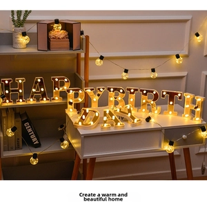 Detail of LED Happy Birthday golden mirror lights with decorative warm globe string lights