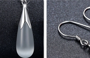 Macro detail of S925 silver teardrop earrings with translucent moonstone and hook design
