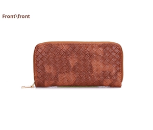 Detailed view of dark brown woven leather wallet with gold zipper and textured surface