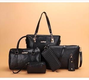Detail of 6-piece black woven texture handbag set with elegant gold hardware accents