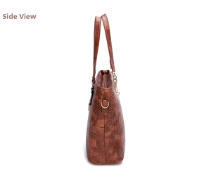 Side view detail of a dark brown woven texture tote bag with golden D-ring hardware