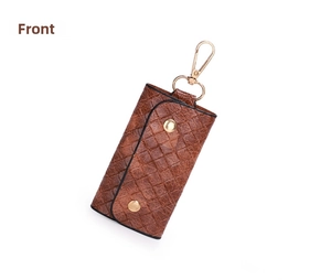 Detail of dark brown woven texture key pouch with gold metal buttons and lobster clasp