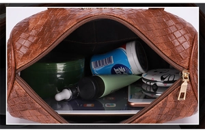 Detailed view of brown woven handbag interior showing spacious capacity for essentials