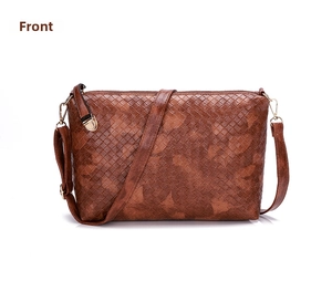 Detailed front view of brown woven texture crossbody bag with gold metal hooks