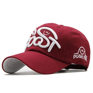 Detail shot of burgundy cotton baseball cap with 3D embroidery and side smile logo