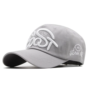 Close-up of gray baseball cap featuring white 3D embroidery with FAST text and smiley icons