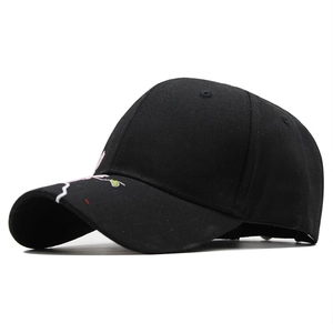 Close-up of pink cherry blossom embroidery on a black cotton baseball cap visor