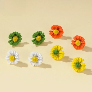 Detailed macro view of four colorful daisy stud earring sets with 3D petal texture
