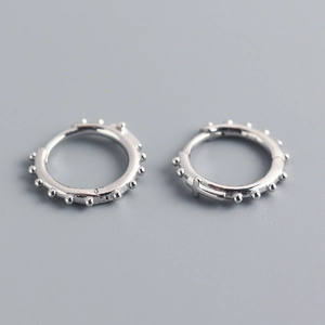 Détail de boucles d'oreilles créoles croix en argent S925 avec perles et fermoir charnière
