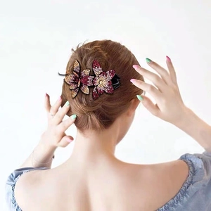 Detailed back view of an elegant floral rhinestone hair clip used for an updo hairstyle