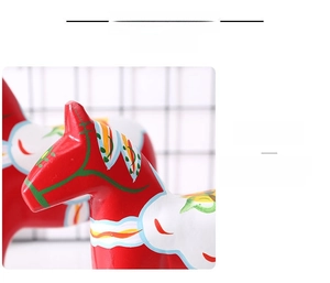Detailed view of hand-painted traditional red wooden Dala horse with floral patterns
