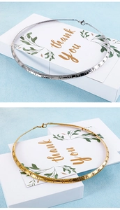Detailed close-up of gold and silver choker necklaces featuring engraved cross patterns